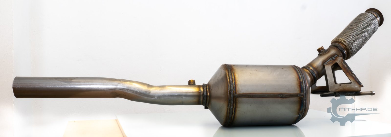 Diesel particulate filter with a length of pipe on a white background