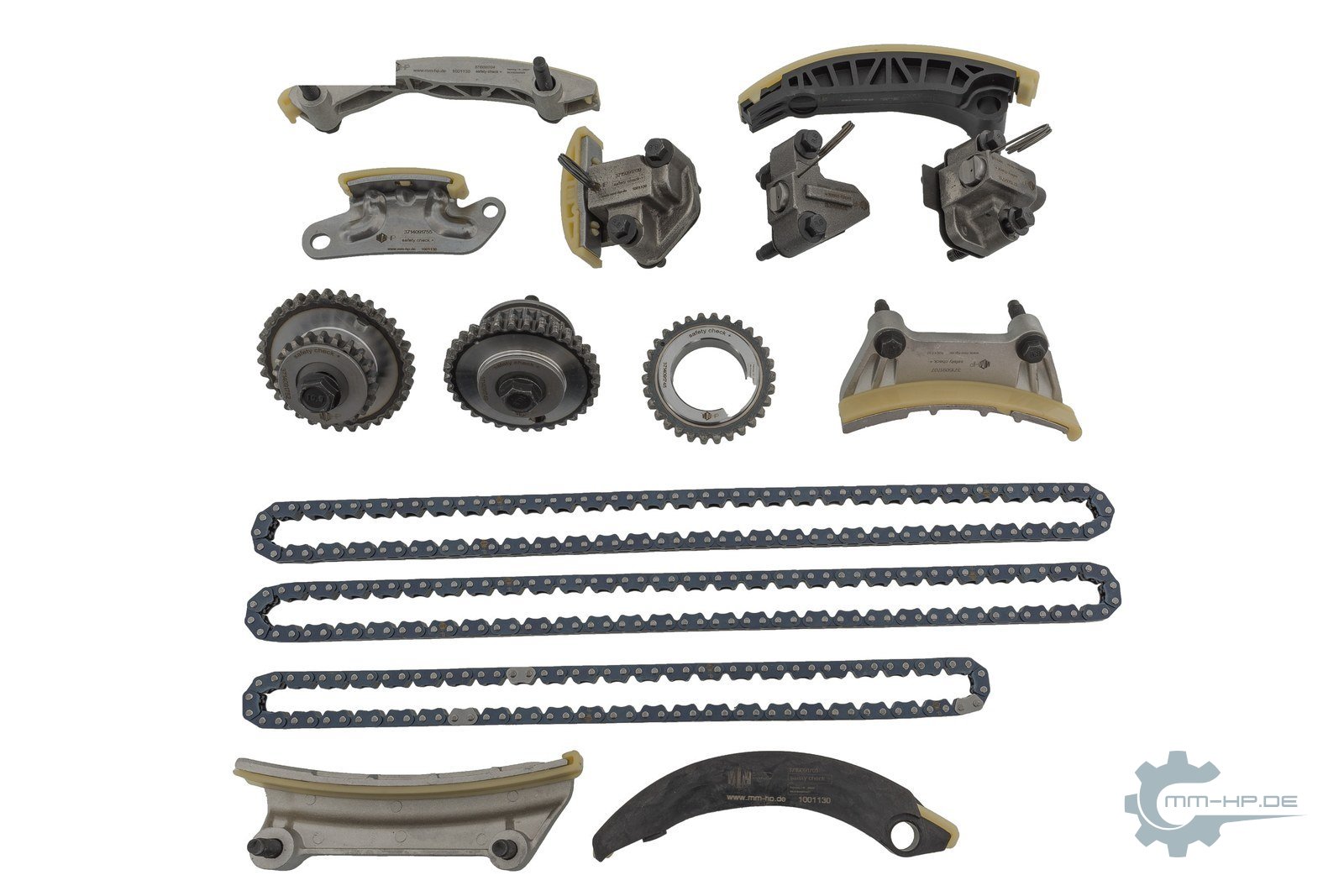 Timing chain kit as new parts, fully laid out: chains, sprockets, rails, tensioners and small parts