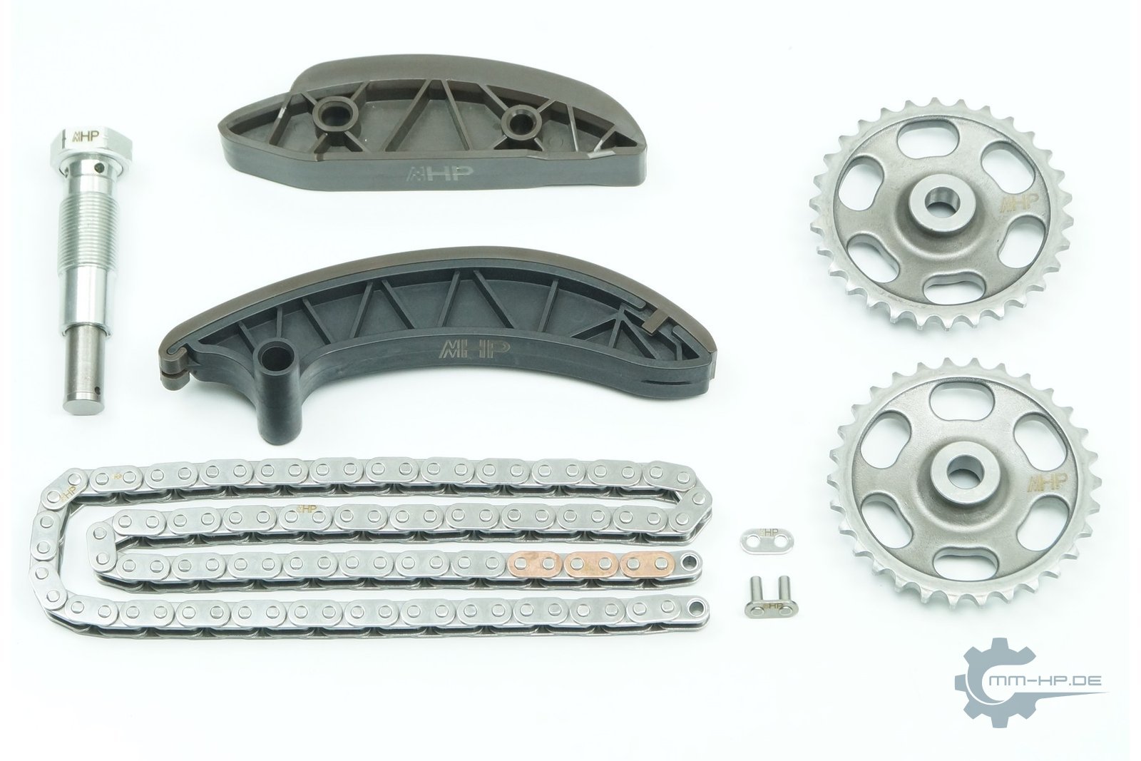 New timing chain kit on a white background: roller chain, two sprockets, two plastic rails and a screw-in chain tensioner