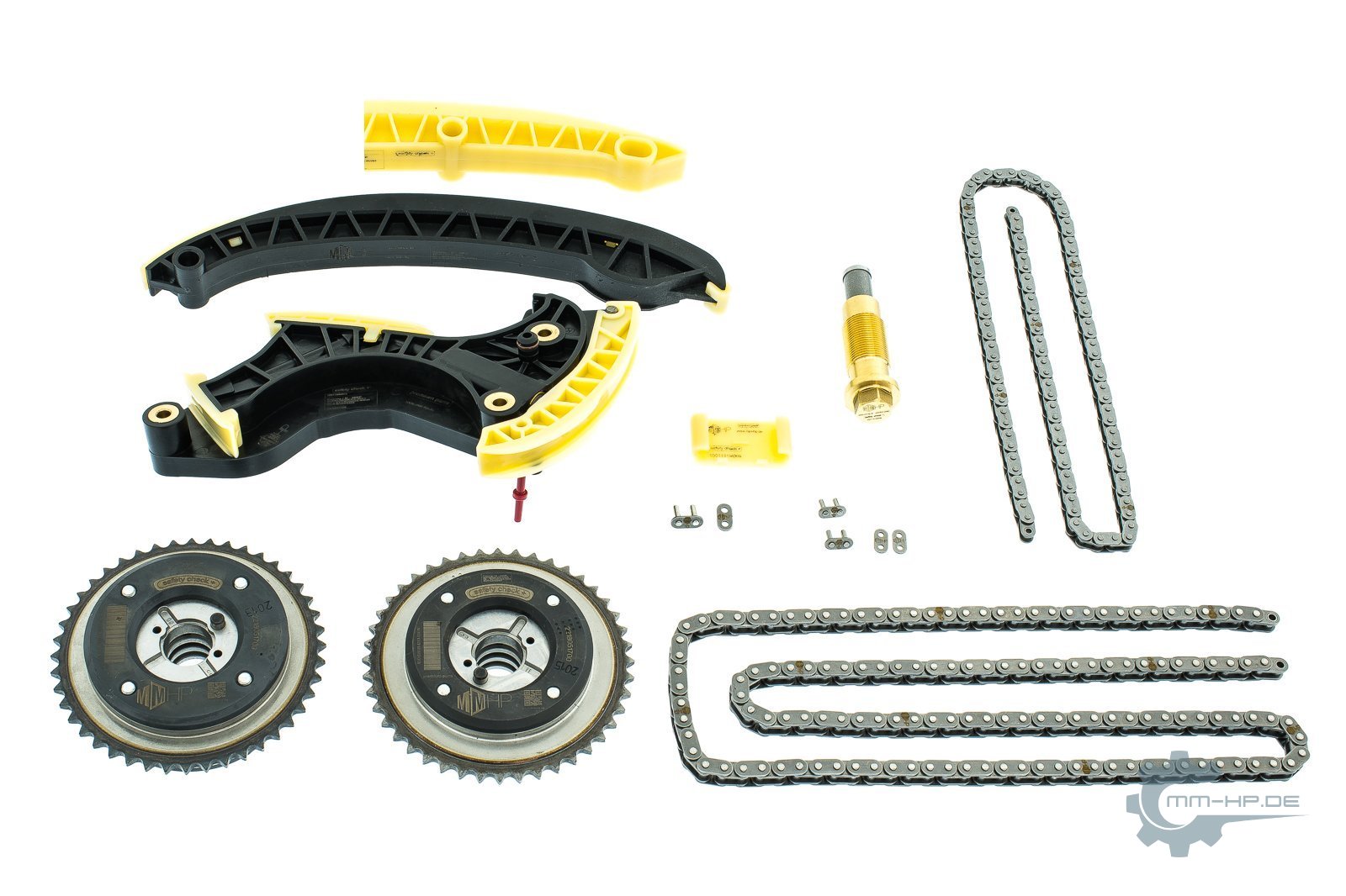 Timing chain kit as new parts: rails with a black carrier and a translucent yellowish sliding layer, plus chains, sprockets and tensioner