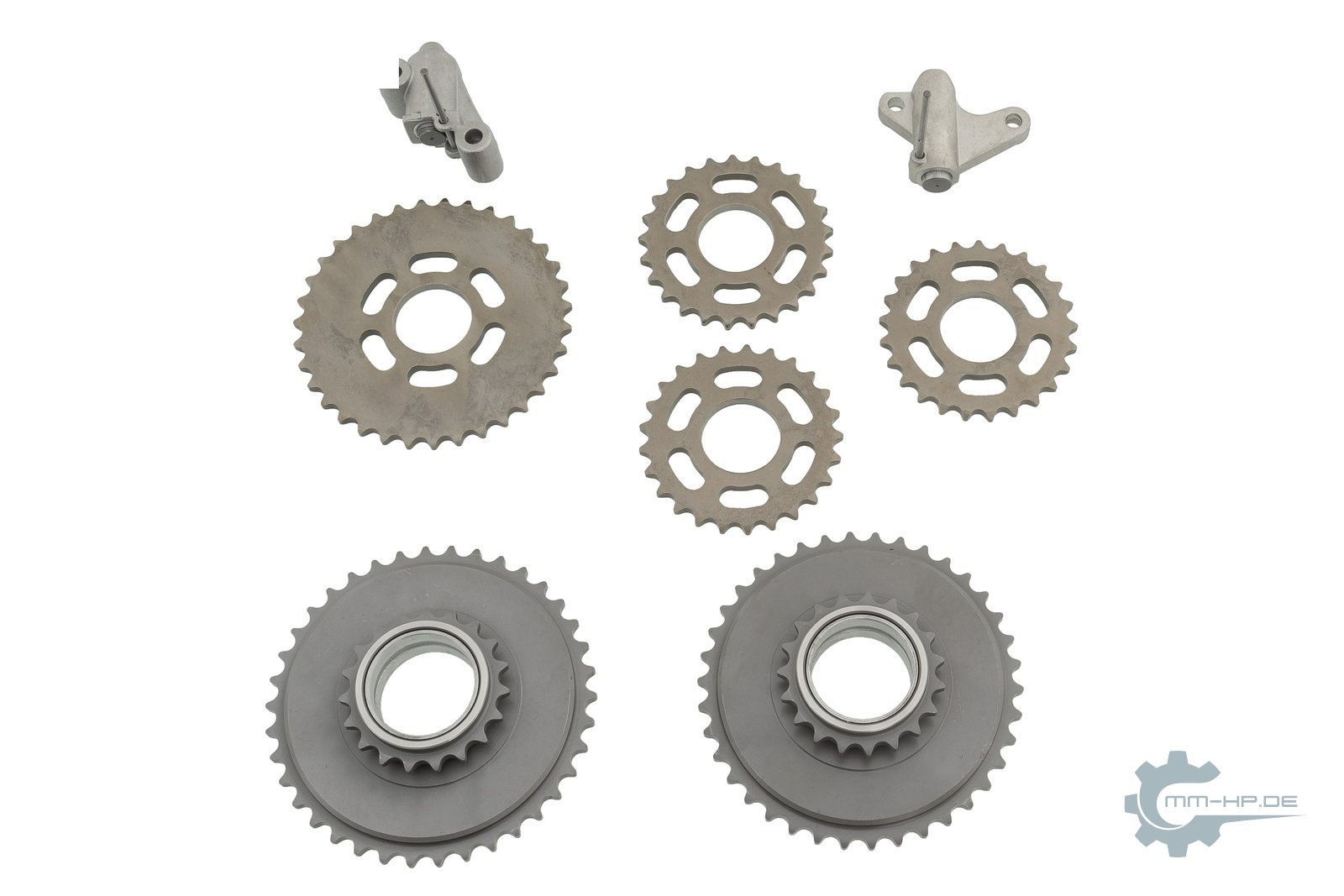 Sprockets of a V6 timing drive as new parts, with two small chain tensioners
